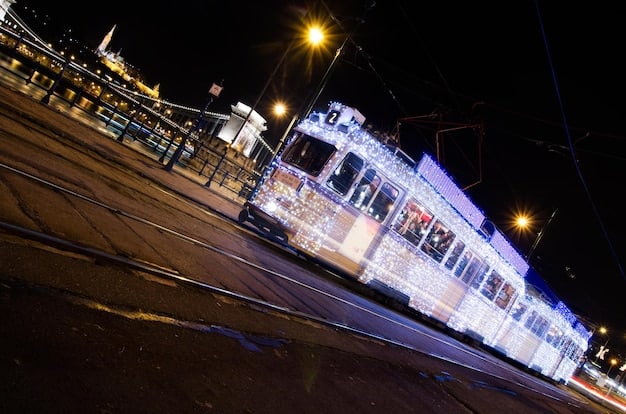 A long, modern light rail train gliding gracefully through a bustling downtown area at dusk. The train's windows reflect the city lights, and pedestrians are visible on the sidewalks, some waiting at a train station. The scene conveys efficient urban movement and a commitment to public transit.