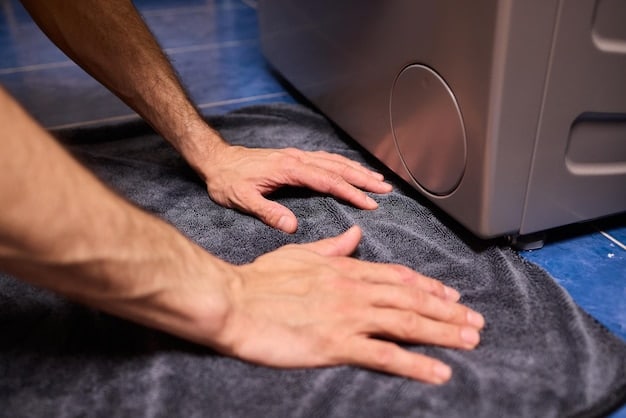 A close-up of a hand cleaning the lint trap of a clothes dryer, emphasizing maintenance for energy efficiency.