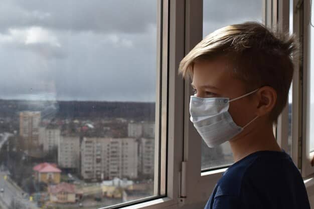 A child with an inhaler, looking out a window at a hazy, polluted city skyline, emphasizing childhood vulnerability to respiratory issues.