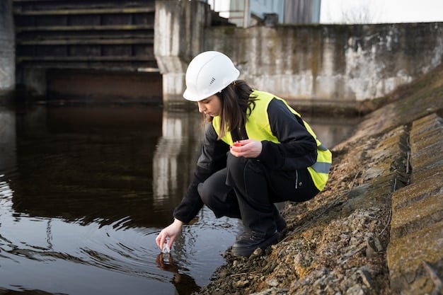 Engineers in hard hats inspecting a flood-resistant barrier being constructed along a river in an urban area, demonstrating infrastructure adaptation efforts. Construction equipment is visible in the background.