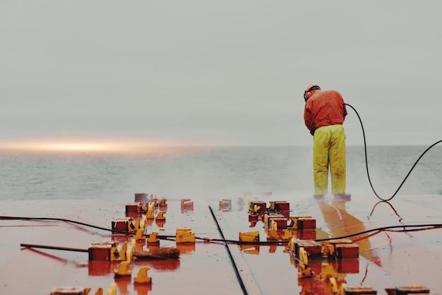 A researcher cleaning biofouling from a submerged sensor unit of a coastal monitoring buoy, highlighting the practical maintenance challenges and field work.