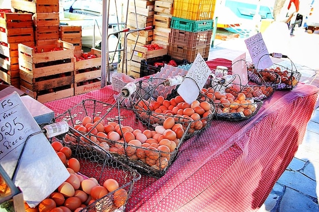 A vibrant local market scene in a coastal town, with locals selling fresh produce, handmade crafts, and traditional foods, illustrating the economic benefits of supporting local businesses in sustainable tourism.