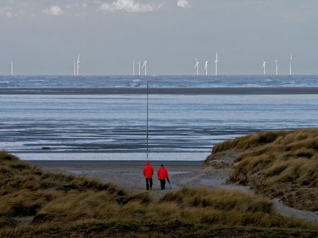An offshore wind farm installation being carefully moved into place, with marine biologists observing nearby marine activity. The scene conveys a blend of industrial progress and environmental vigilance.