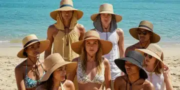 2025 Summer Hat Trends: Sun Protection & Style Guide Diverse individuals modeling 2025 summer hats on a sunny beach for style and sun protection.